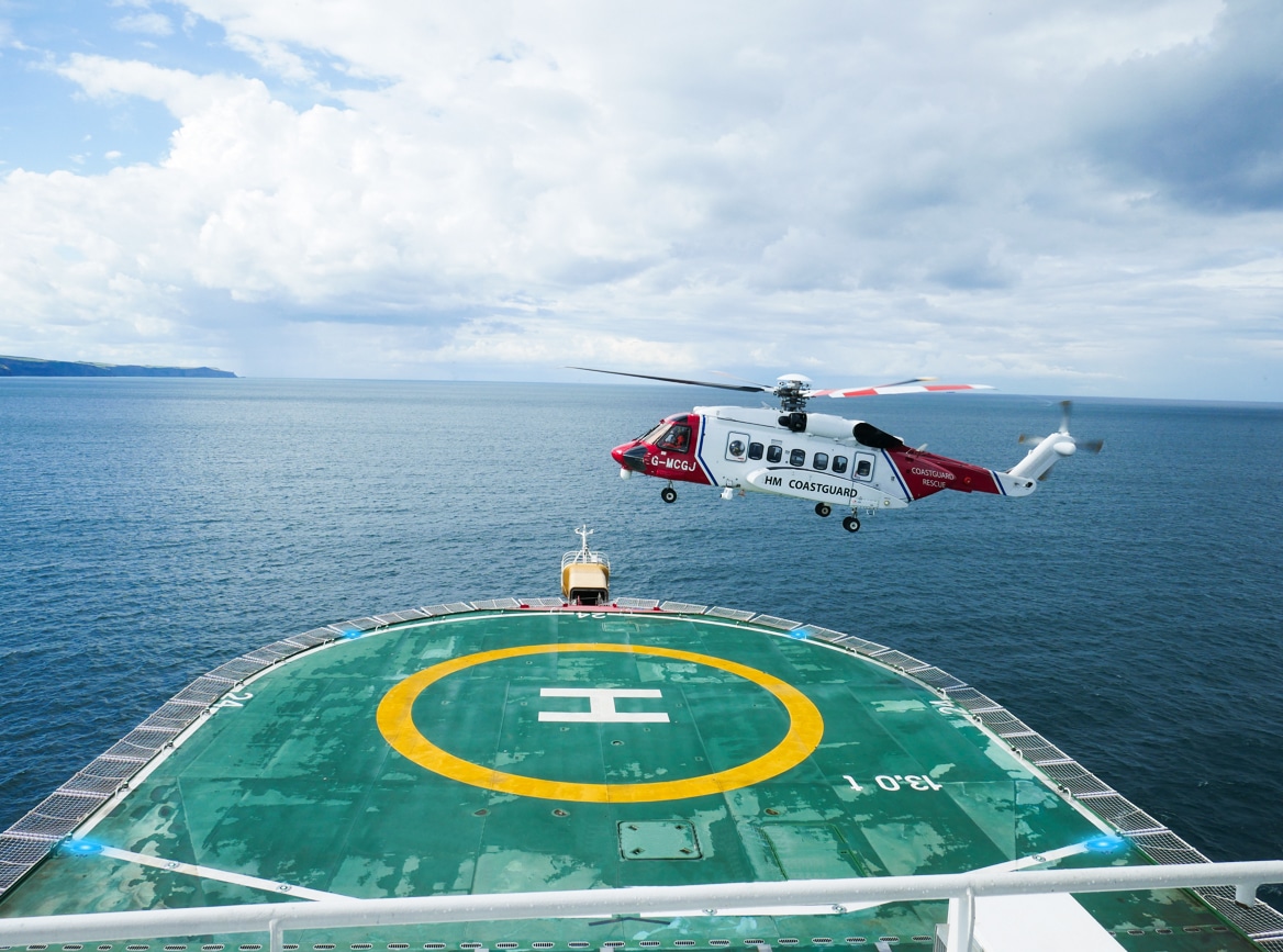 a helicopter flying over the water