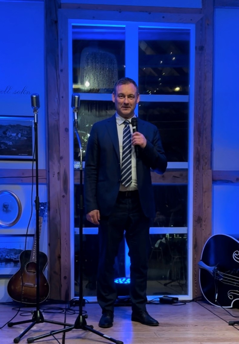 a man in a suit holding a microphone