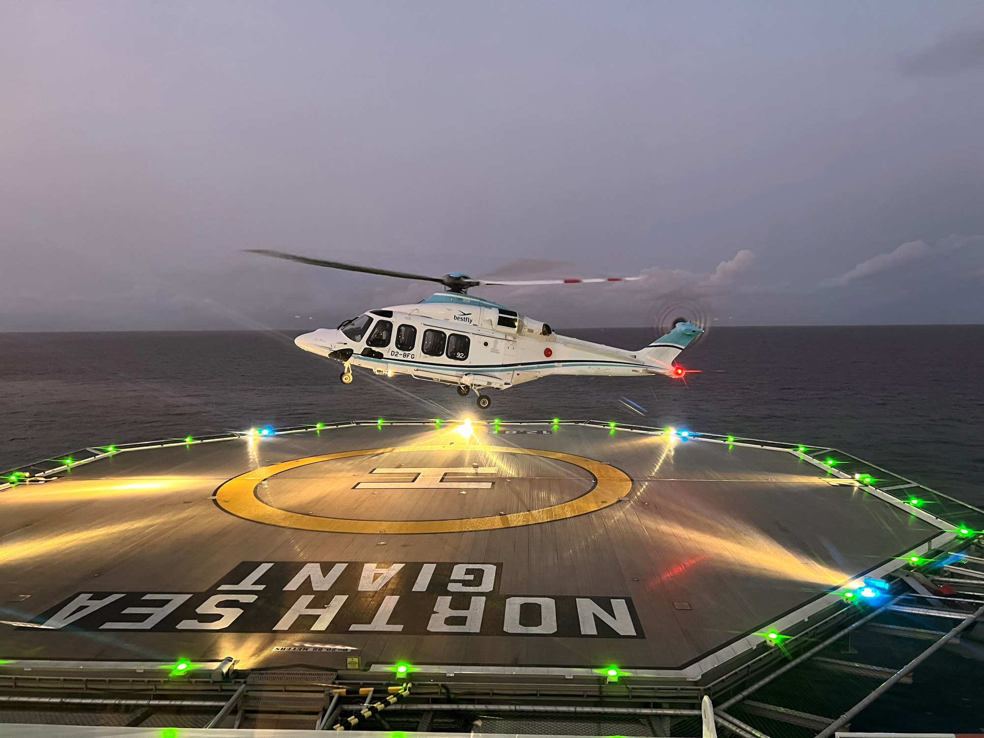 a helicopter landing on a landing pad