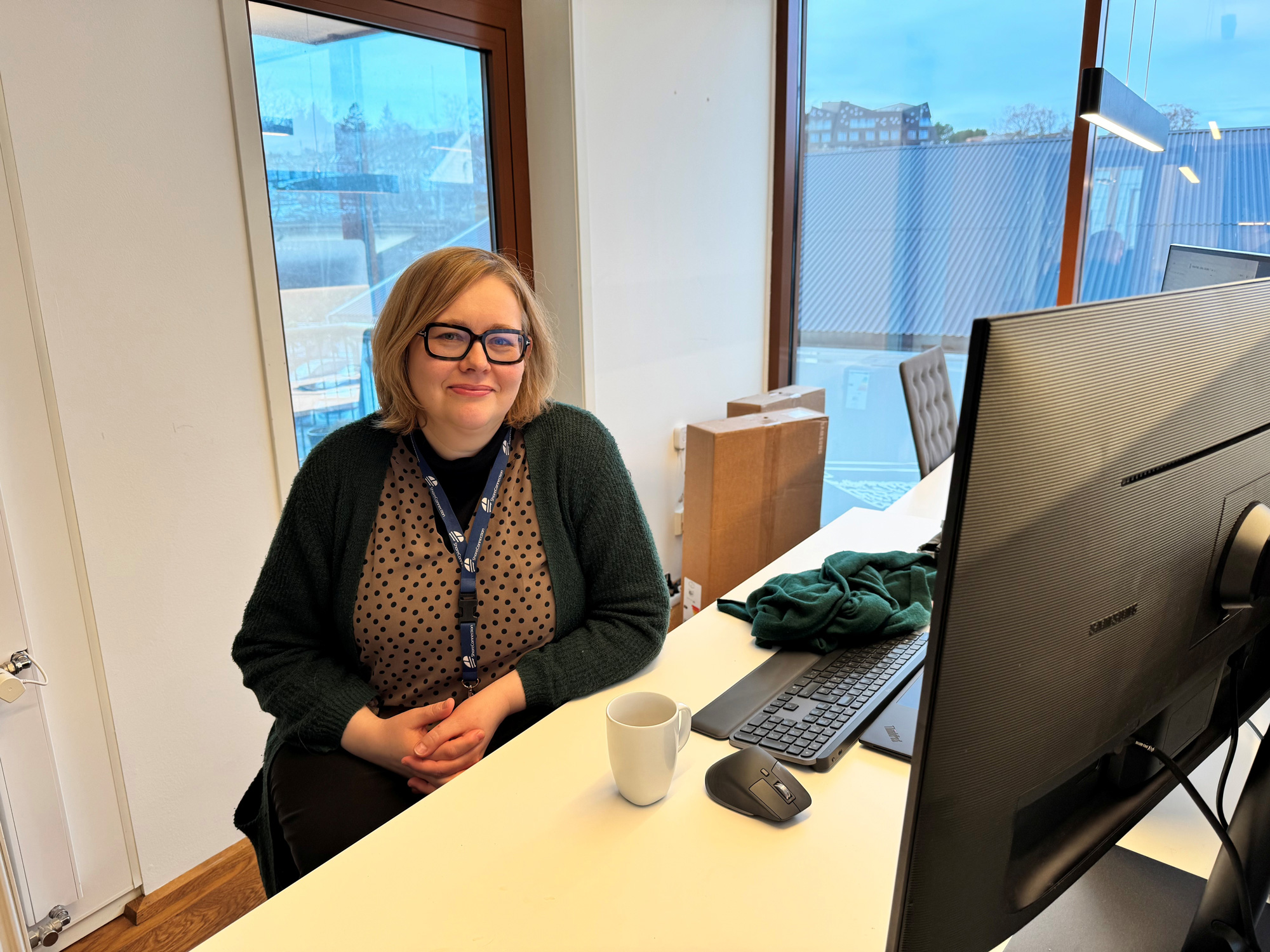 a woman sitting at a desk with a computer