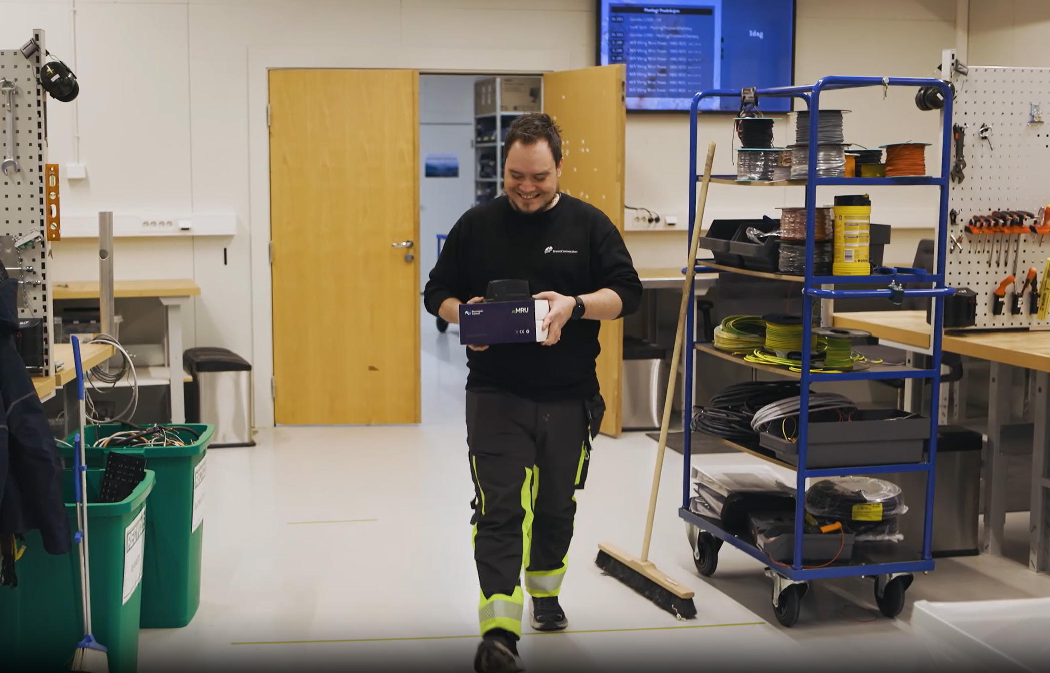 a man in a room with a cart and a phone