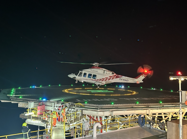 a helicopter landing on a platform